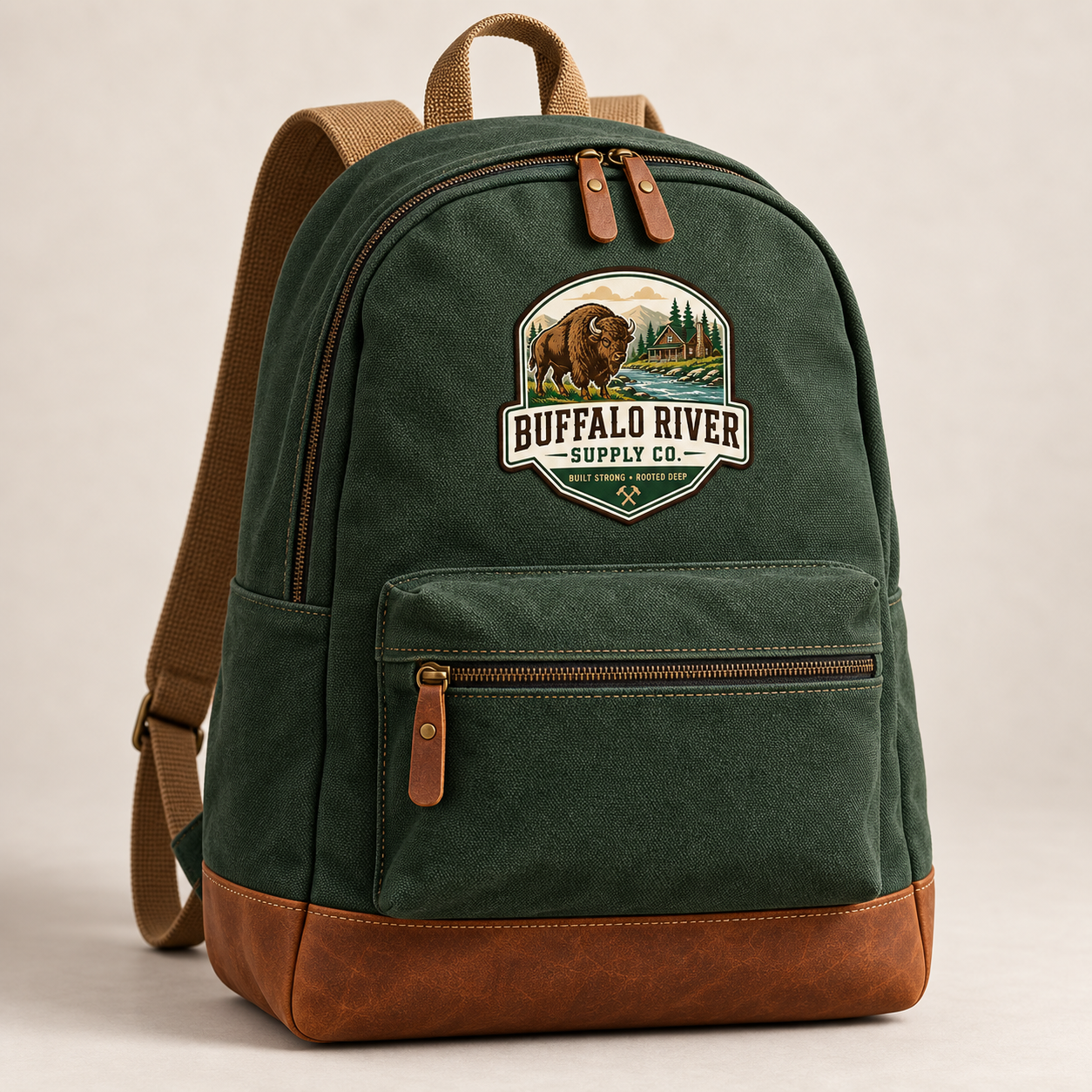 Forest canvas backpack with tan straps, leather details, and the complete Buffalo River Supply Co. scenic patch
